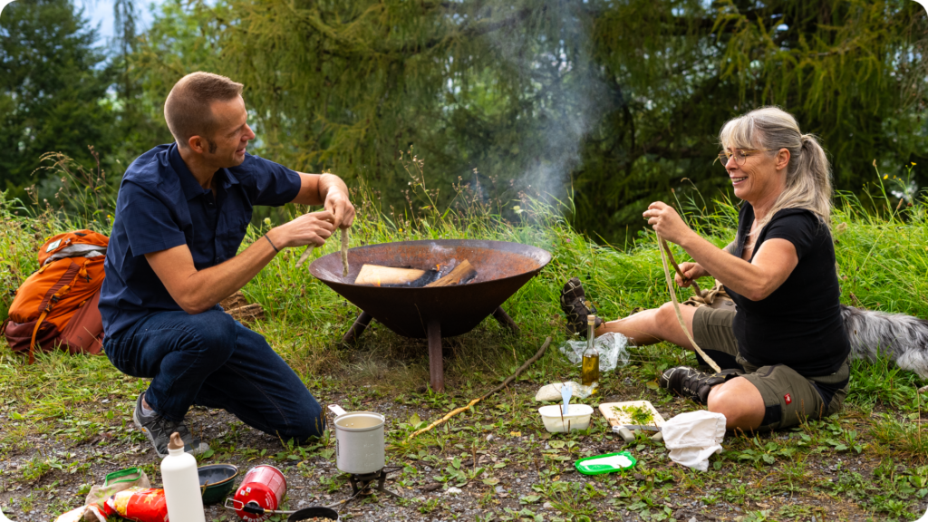 chef corso and a local guide cooking outdoors in liechtenstein while filming for the tv show outdoor eats